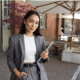 a woman in a business suit holding a tablet